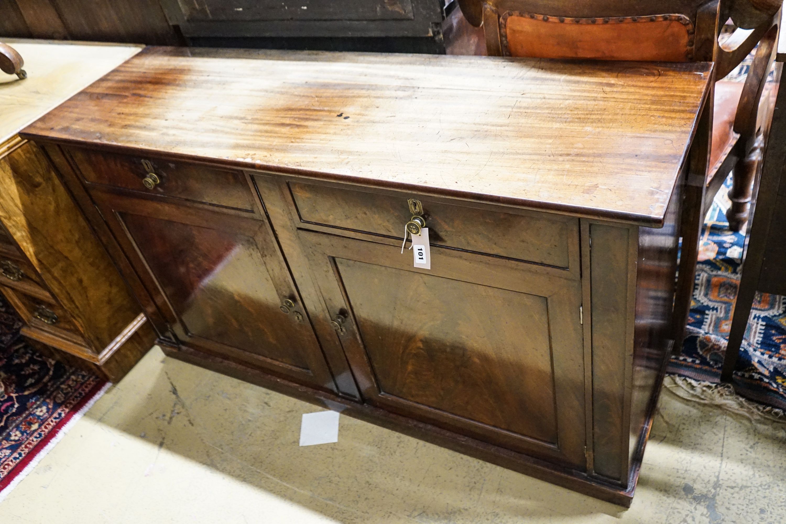 A Regency mahogany low cabinet fitted with two drawers, over a pair of cupboard doors and plinth base, width 138cm, depth 43cm, height 76cm